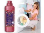 Large pink bottle of Tesori d’Oriente Persian Dream laundry softener beside a woman loading a front-loading washing machine.