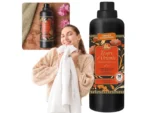 Smiling woman in a beige sweater holds a white towel beside a large bottle of Tesori d’Oriente Japanese Rituals laundry detergent.